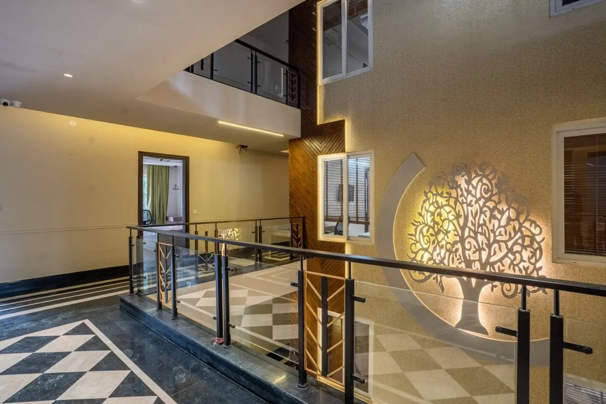 The atrium at Commune Anant with its carved tree wall