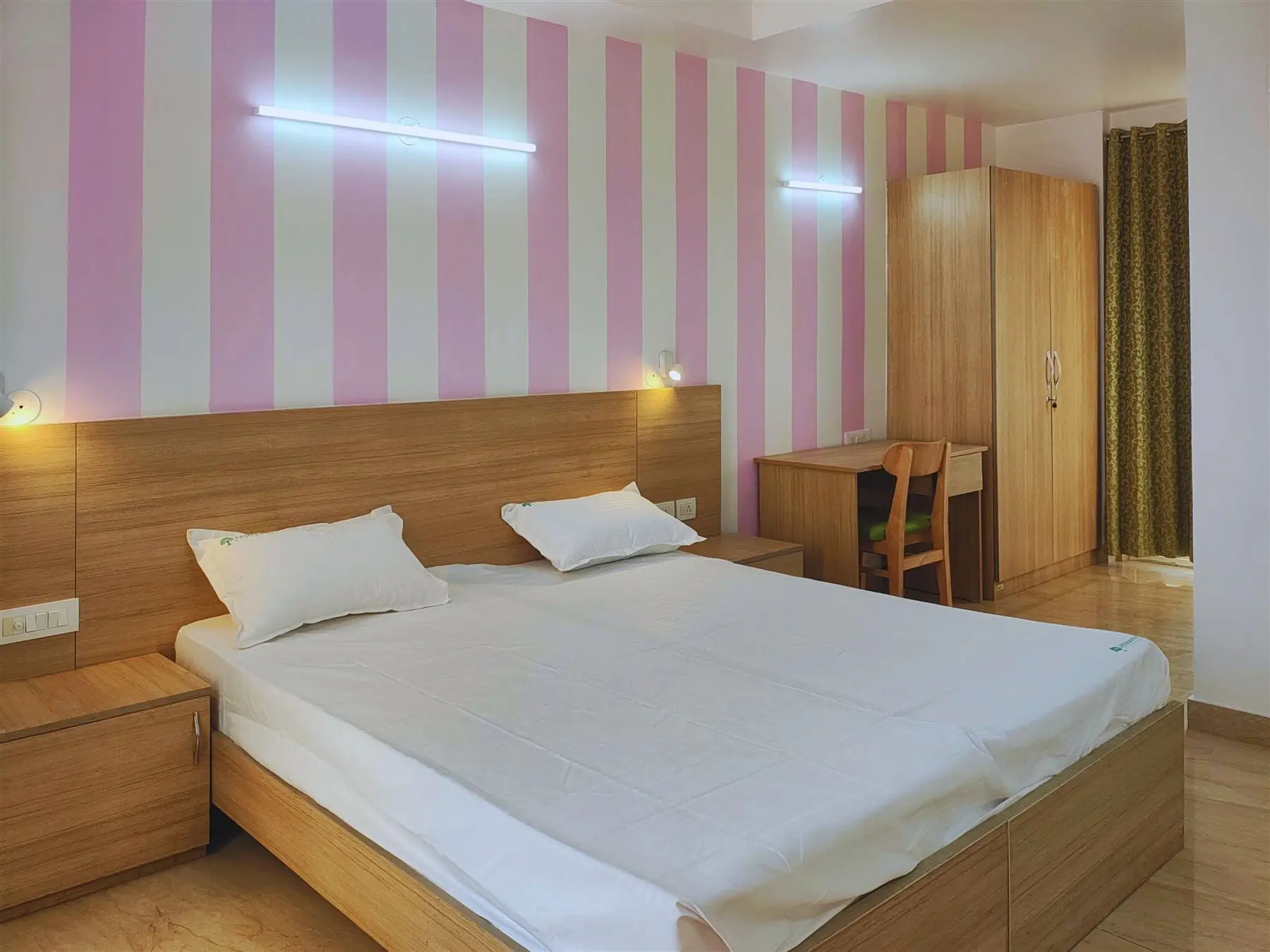 Twin beds and bedside lights in a Commune Collective room