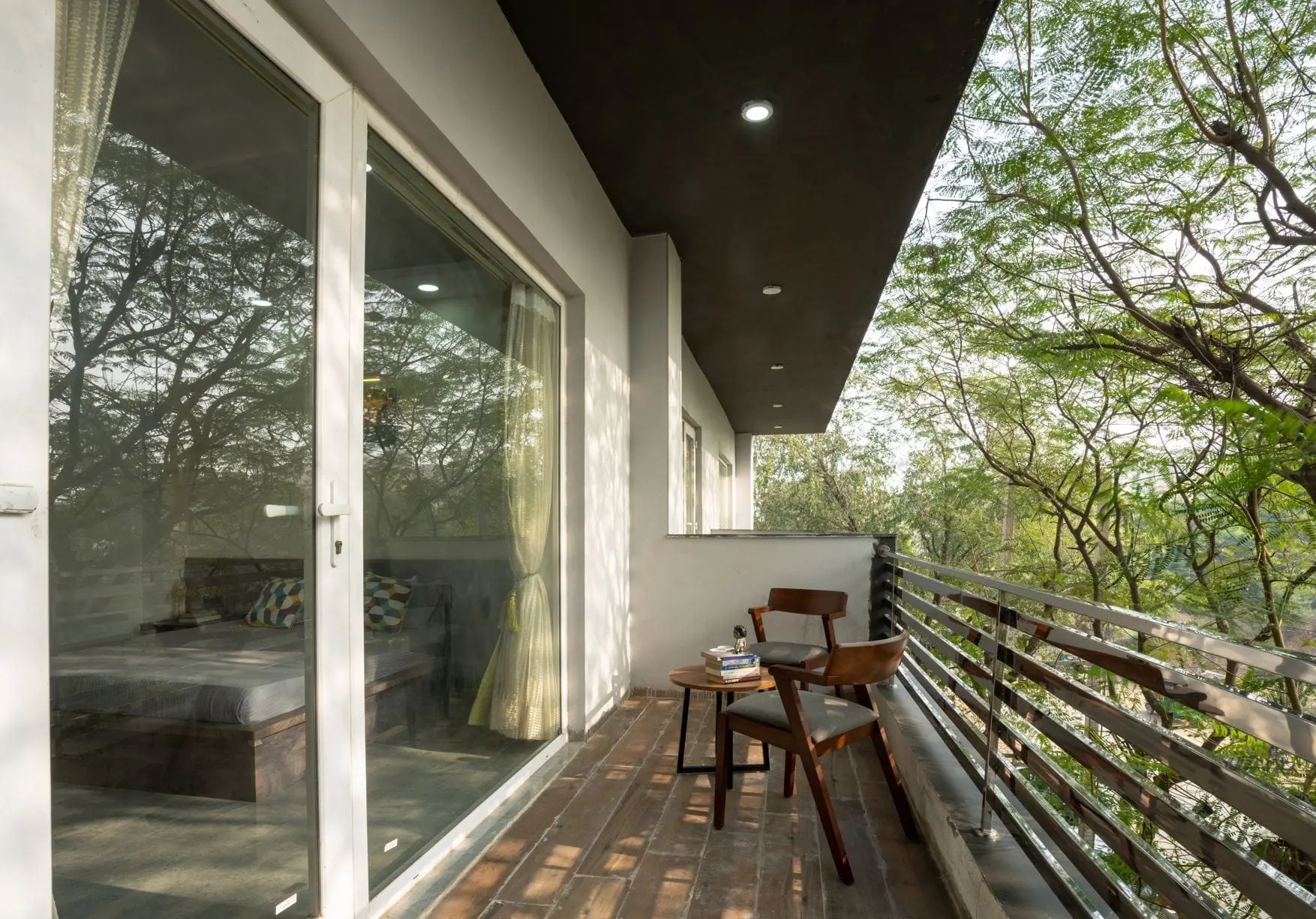 A private balcony at Commune Greenwood looking onto trees