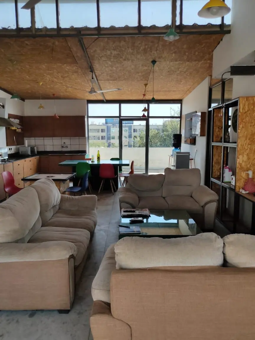 The lounge at Commune Millennium City, lit by tall windows