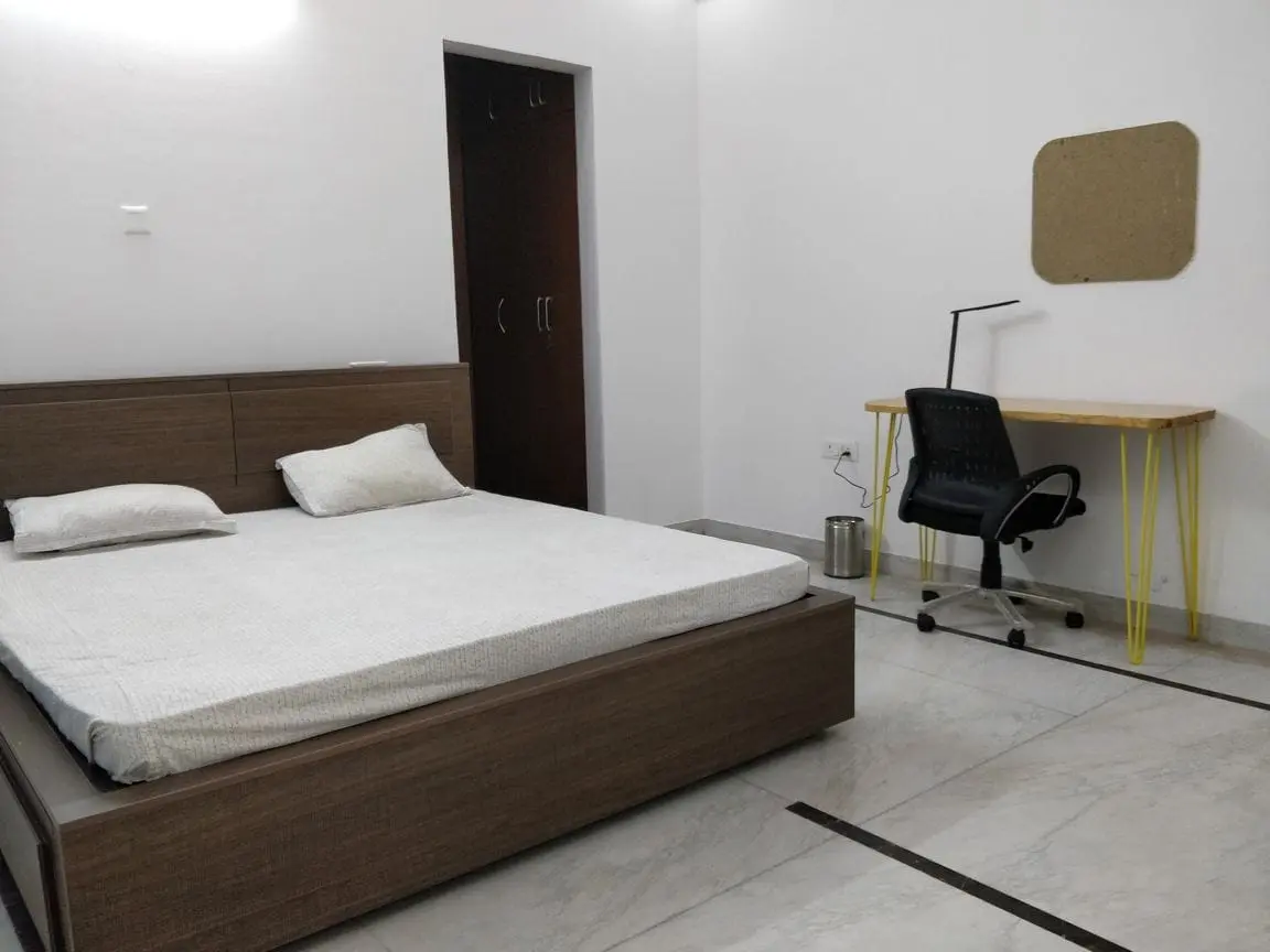A room with a queen bed and work desk at Commune Millennium City