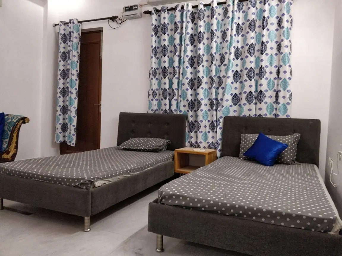 Twin beds in a sharing room at Commune Millennium City