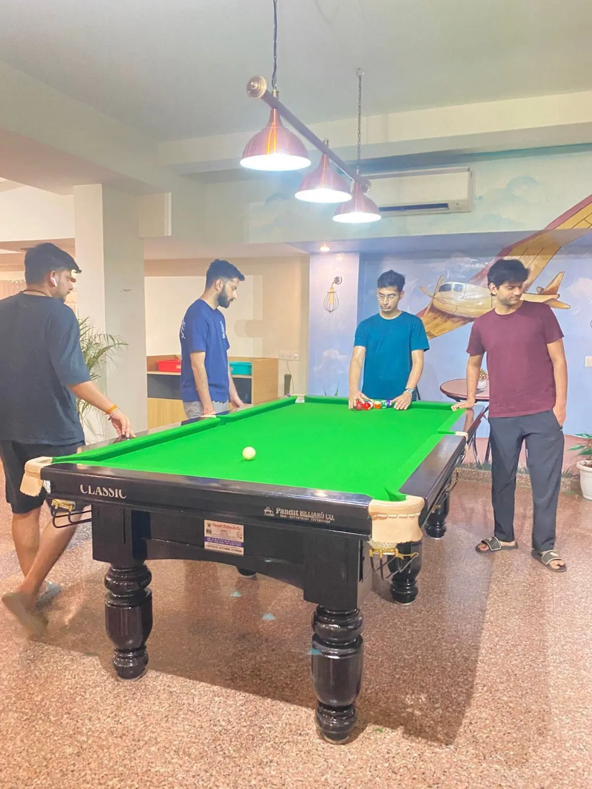 Communrs playing pool in the Commune Nova lounge