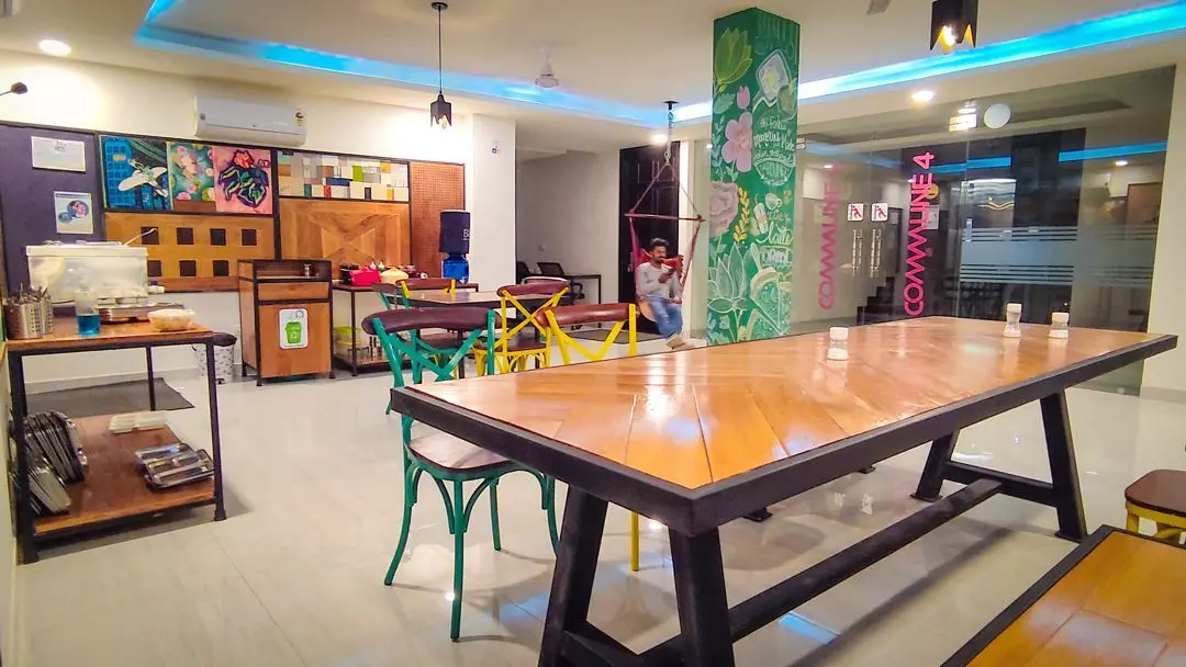 The lounge at Commune Quartex with a long wooden table