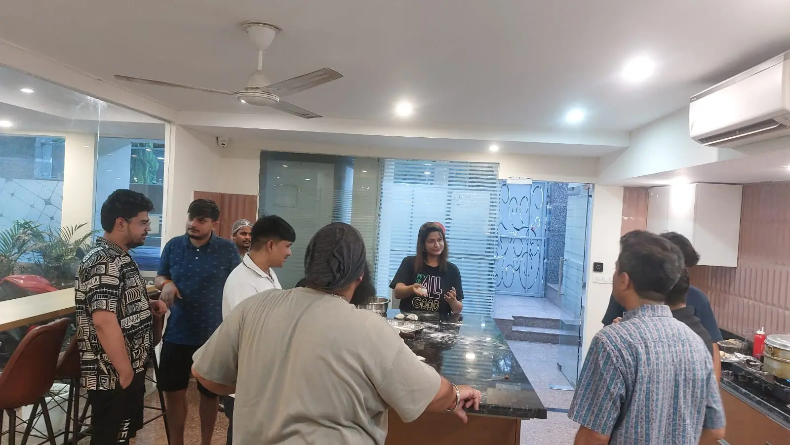 Communrs gathered in the community kitchen as the momo workshop gets started
