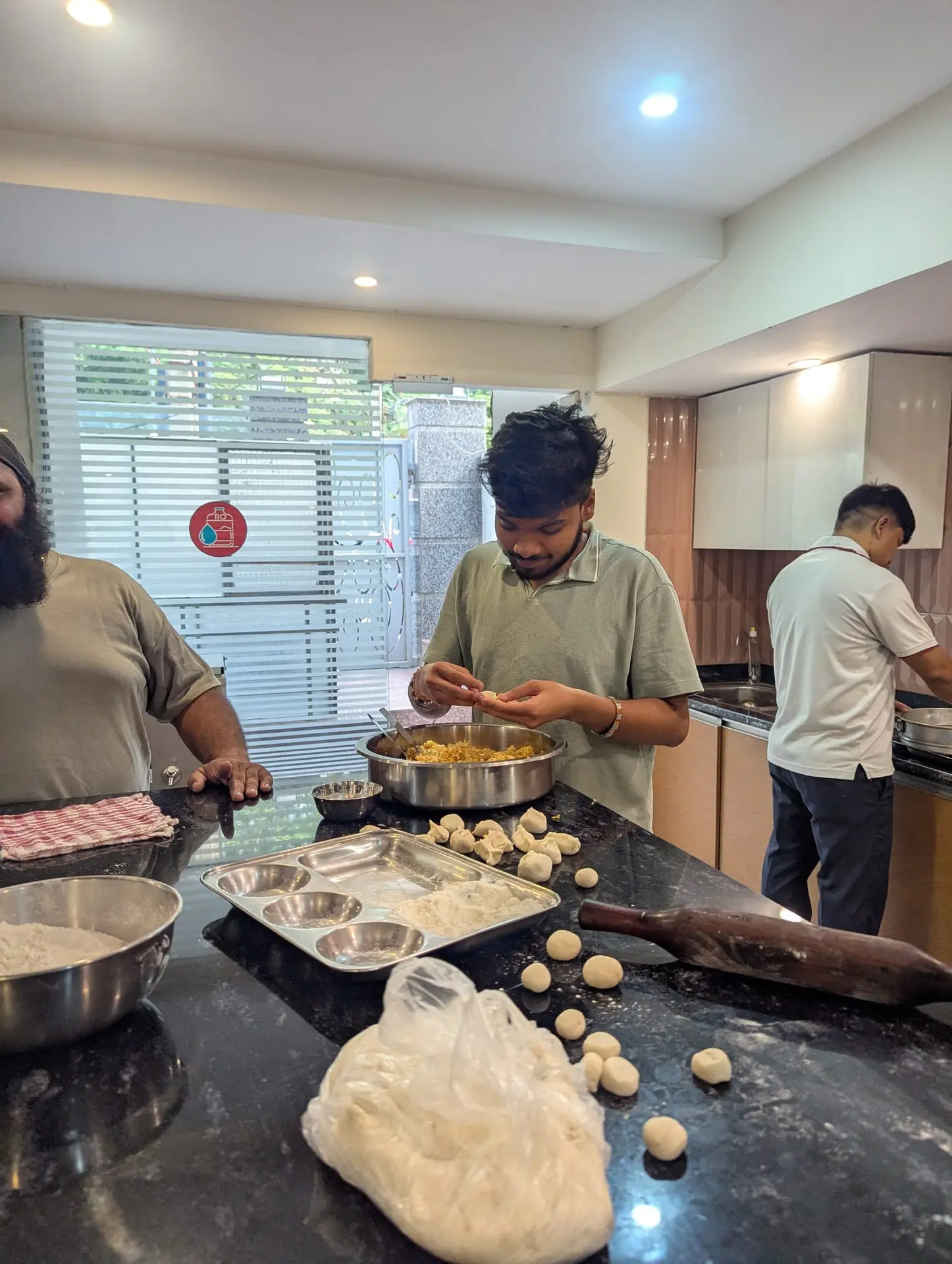 A Communr rolling out momo wrappers