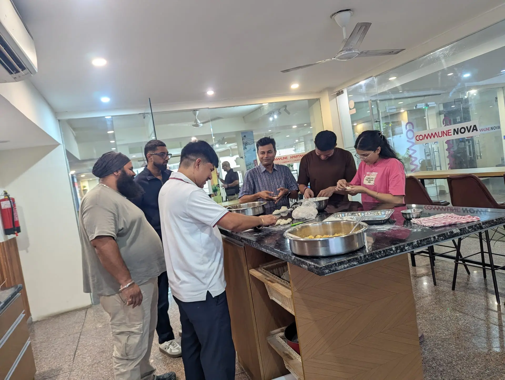 Communrs working together on trays of momos