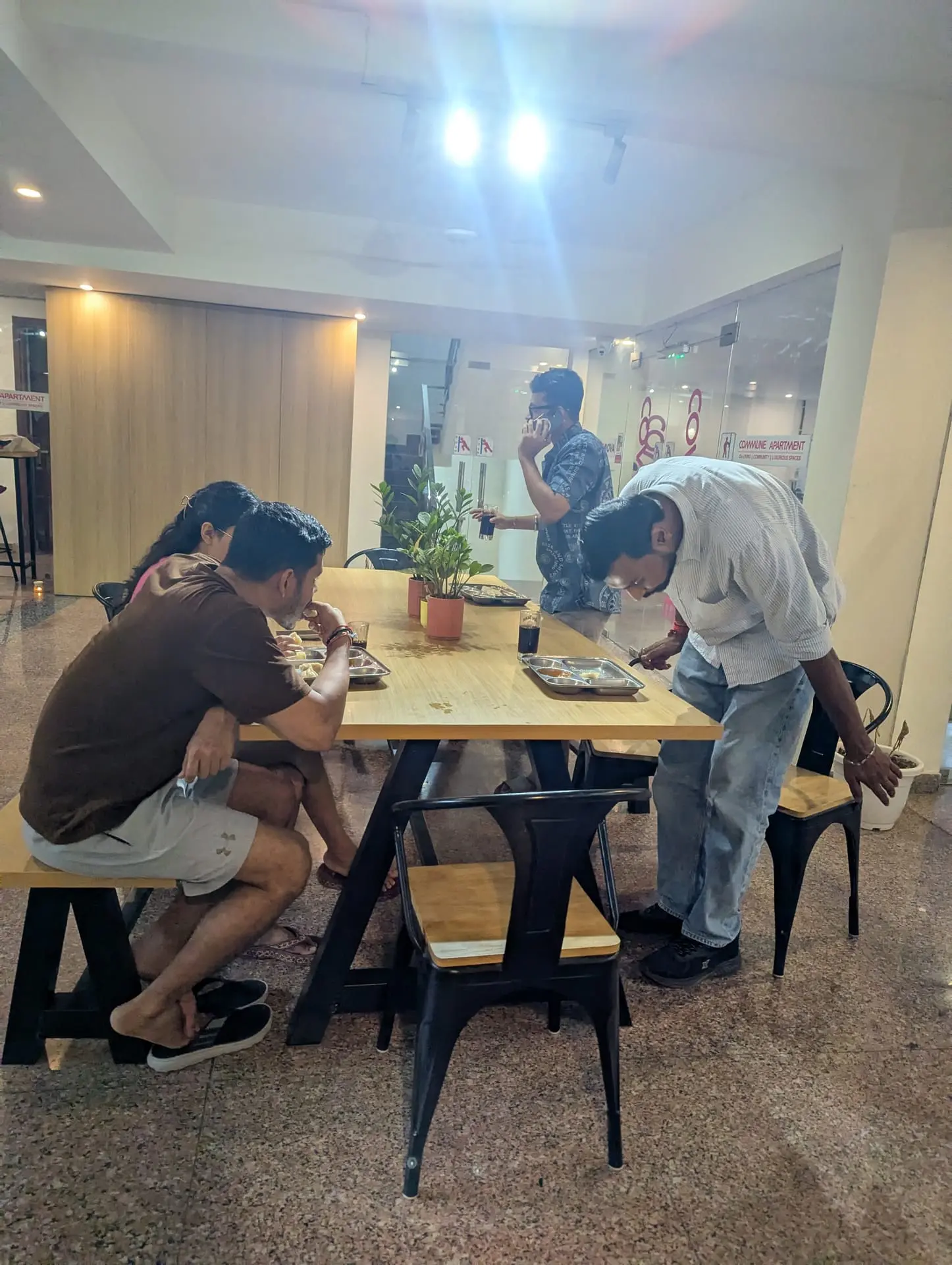 Communrs sitting down to eat the momos they made
