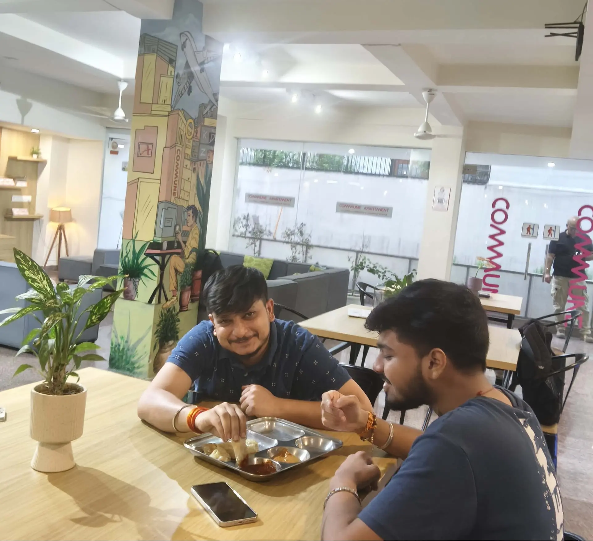 Communrs tucking into their momos at the dining tables