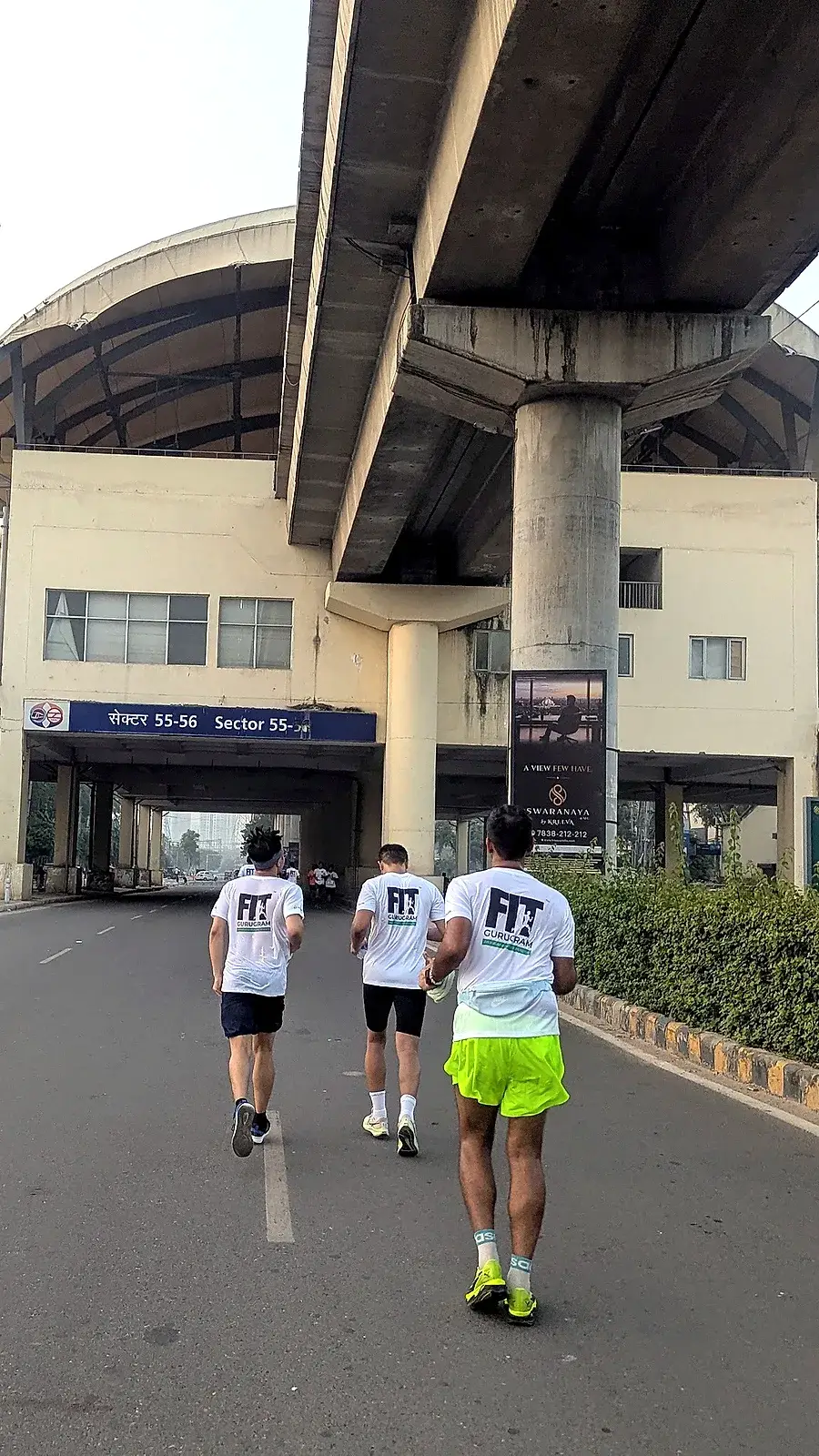 Three Communrs in FIT Gurugram tees running under the Sector 55–56 metro flyover