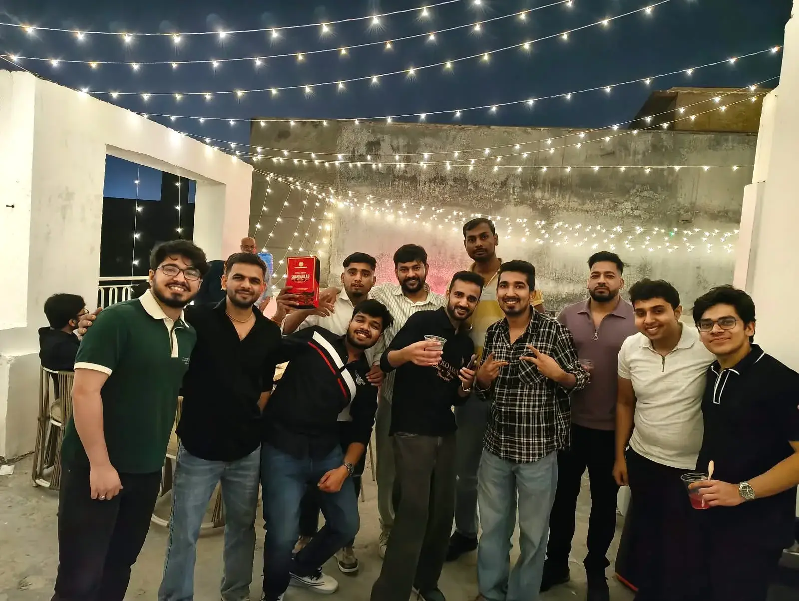 A big group of Communrs posing together under the lights