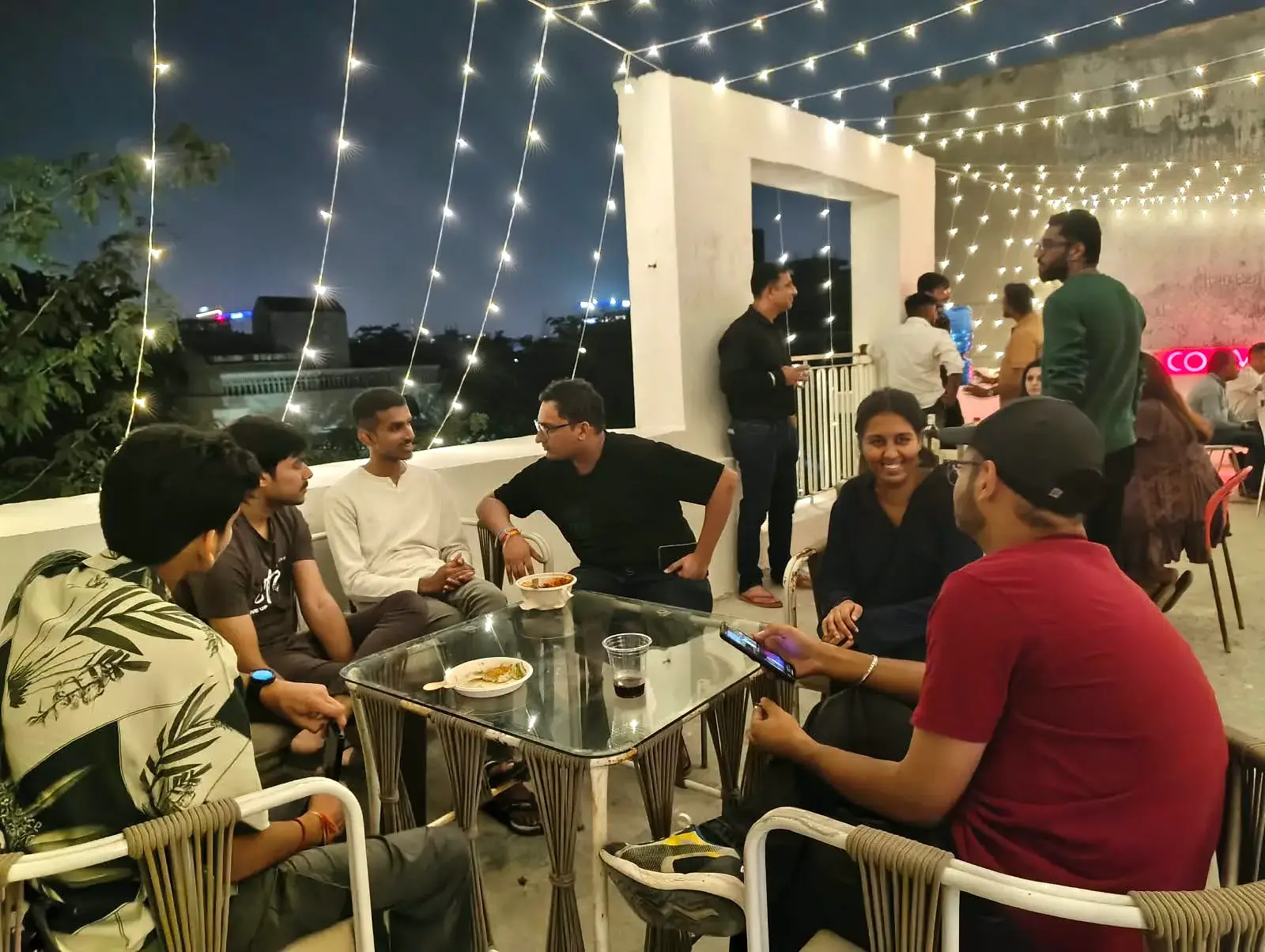 A table of Communrs talking over food and drinks