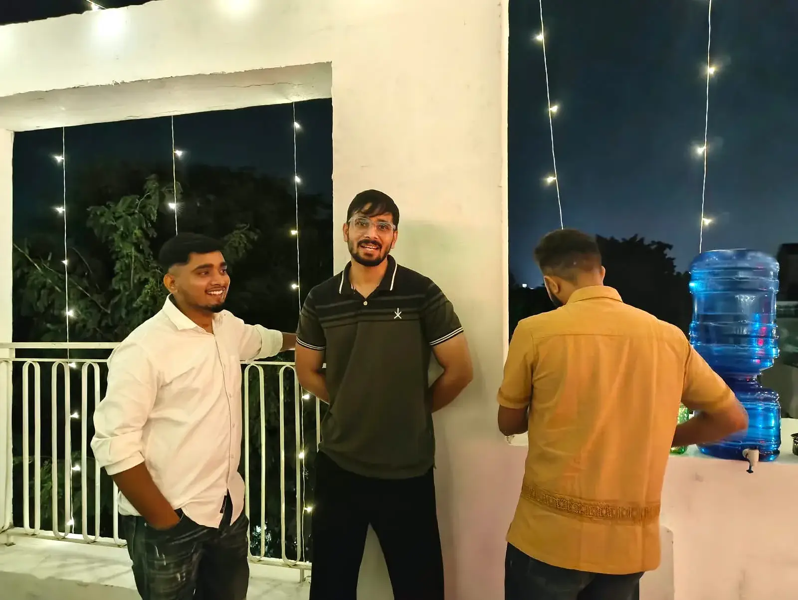 Three Communrs by the water station at the edge of the terrace