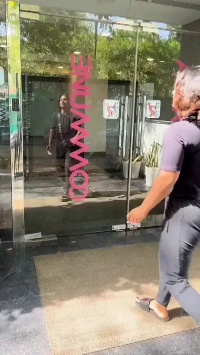 Walking up to the glass doors of a Commune, with the Commune name on the glass