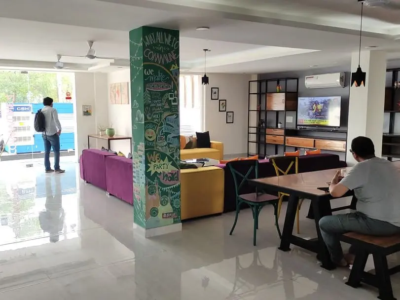 The lounge at Commune Quartex, with its chalkboard pillar, sofas and dining tables