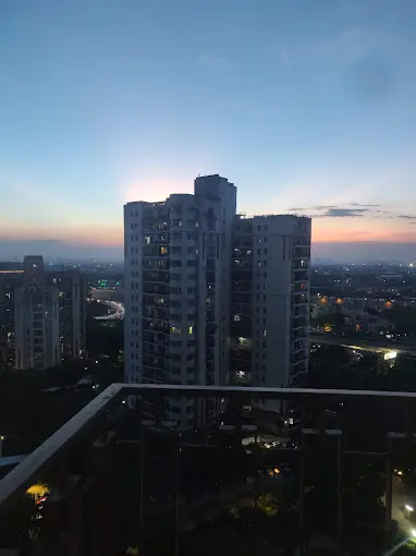 The Gurugram skyline at dusk from a high floor at Essel Tower