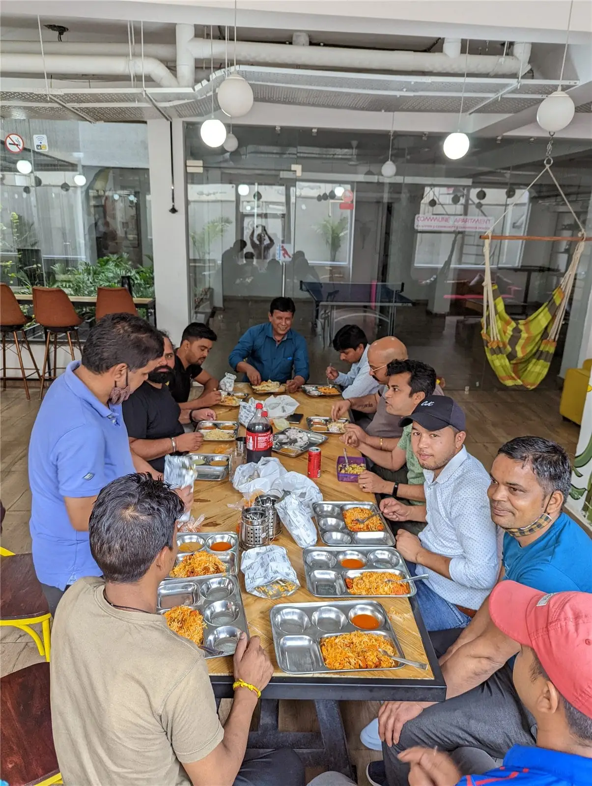 The Commune team sharing a meal in the lounge