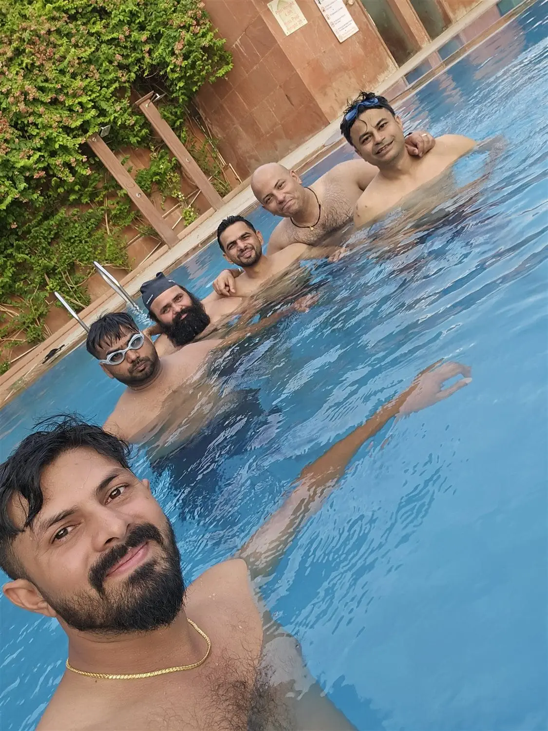 Team Commune together in the pool, June 2026